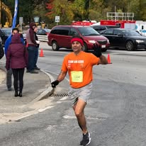 Runner crossing Marine Corps Marathon finish line