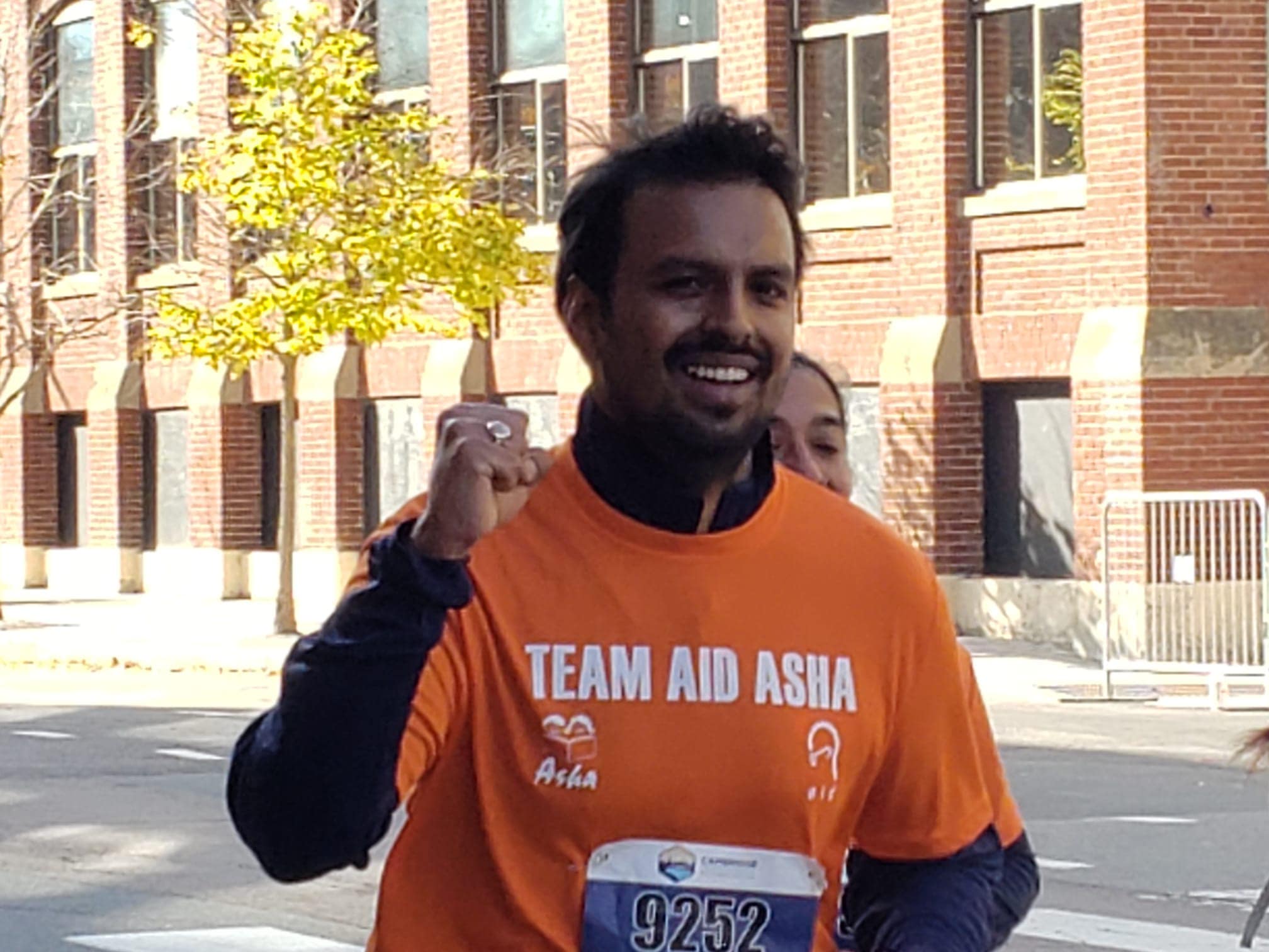 Team selfie at Cambridge Half Marathon banner