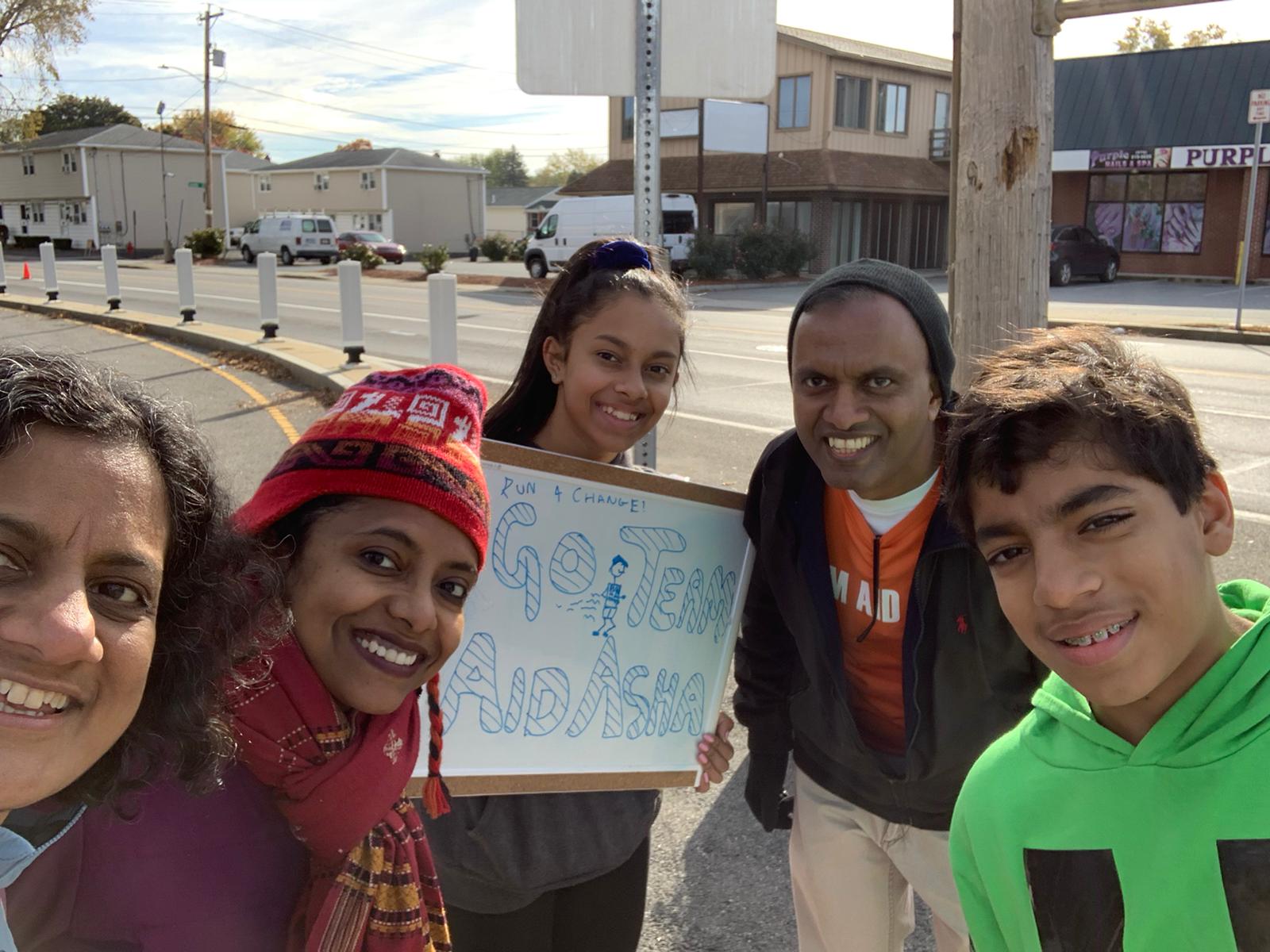 Runner waving mid-race with medal