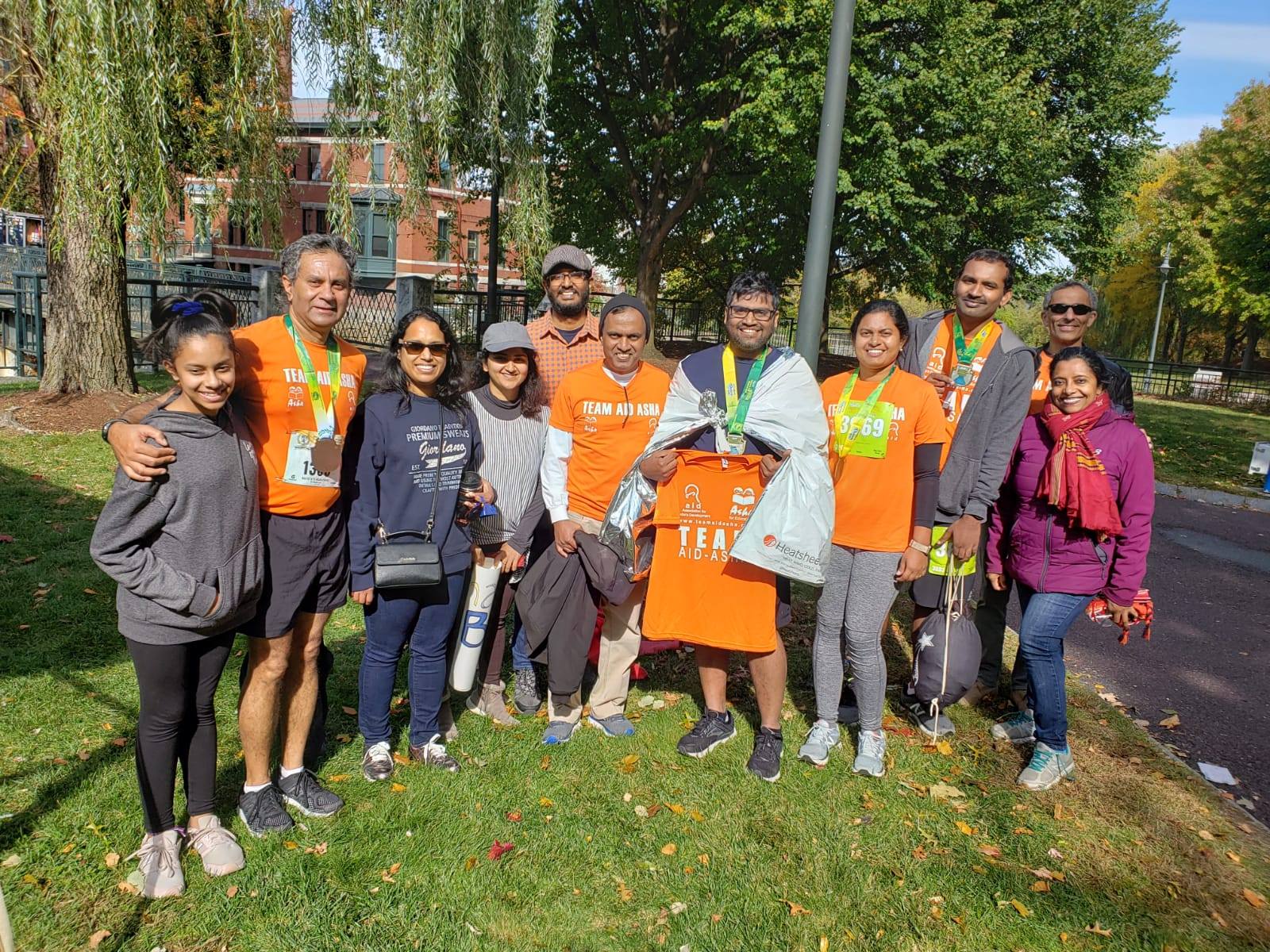 Runner in Team Aid Asha shirt fist pump